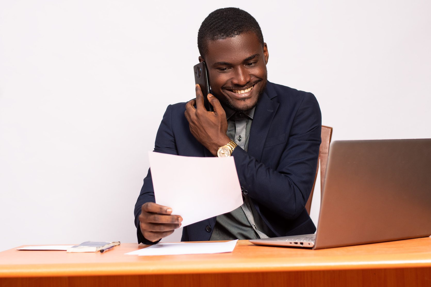 african business man making a phone call while working